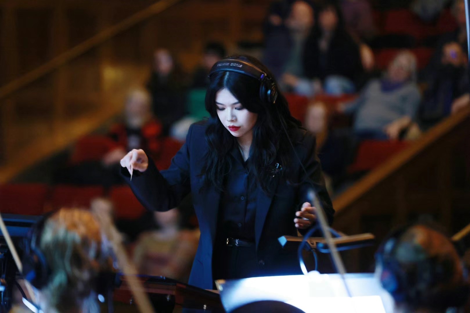 Junwen Wu conducting an ensemble