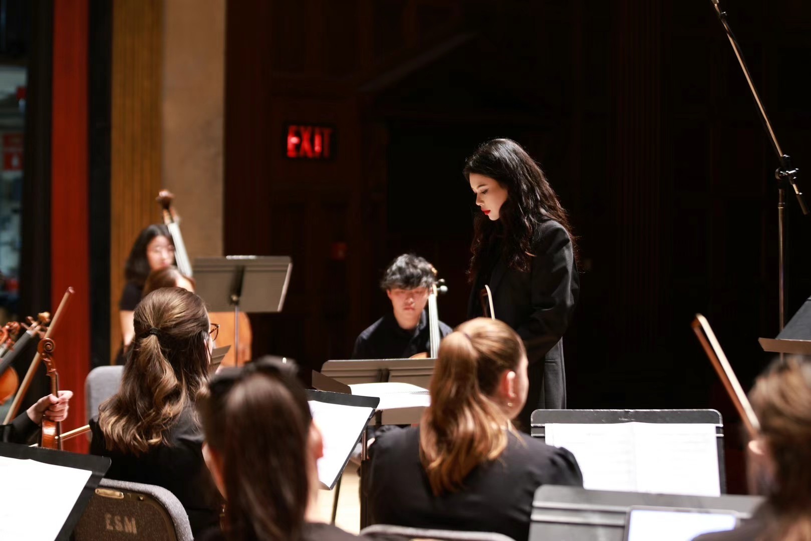 Junwen Wu conducting with orchestra
